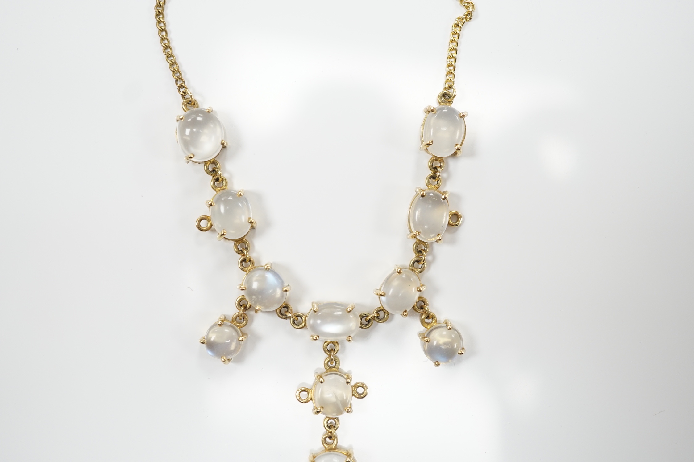 An Edwardian style 9k and cabochon moonstone cluster set drop necklace, 48cm, gross weight 11.2 grams.